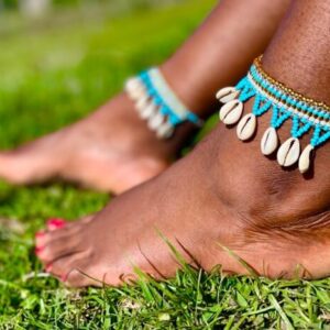 Amanqashela on a stylish, barefoot model sitting on green grass - made with passion by Homba Crafts